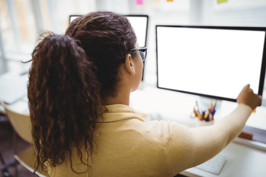 Woman Working on Transparent Computer Monitor in Office Setting