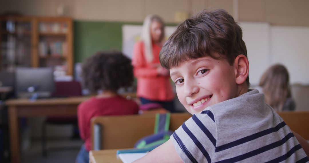 Happy School Boy Smiling in Classroom Turning Around - Free Images, Stock Photos and Pictures on Pikwizard.com