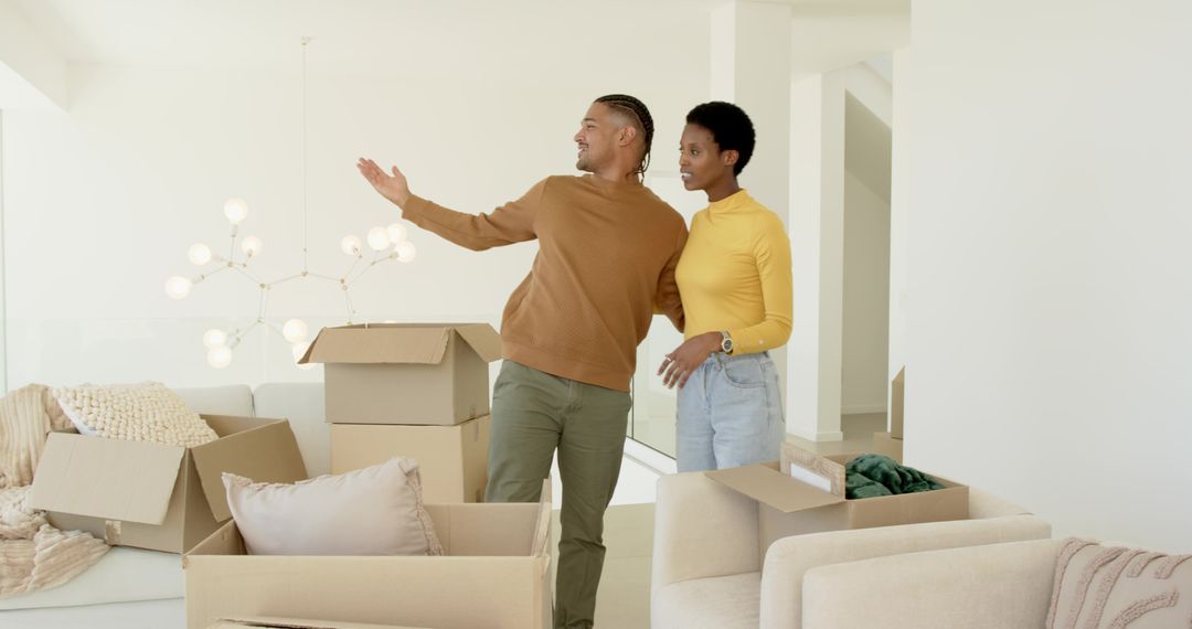 Happy Couple Unpacking Boxes in Stylish Minimalist Home