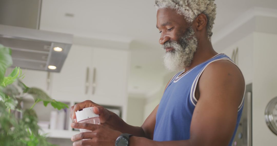 Image of african american senior man preparing smoothie - Free Images, Stock Photos and Pictures on Pikwizard.com