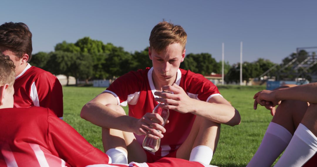 Young Soccer Players Resting and Hydrating - Free Images, Stock Photos and Pictures on Pikwizard.com