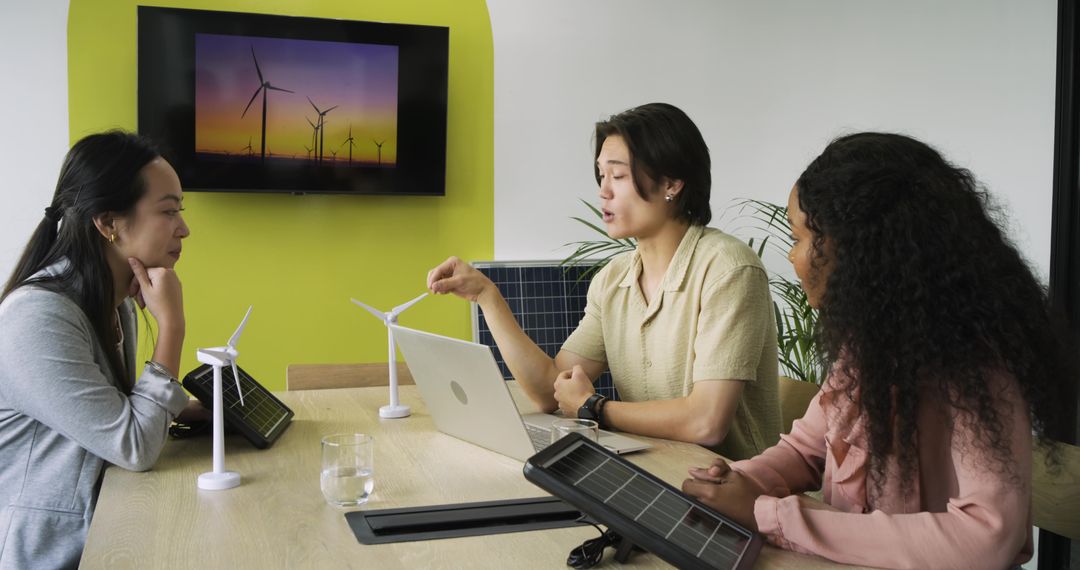 Diverse Team Discussing Renewable Energy Models in Modern Office