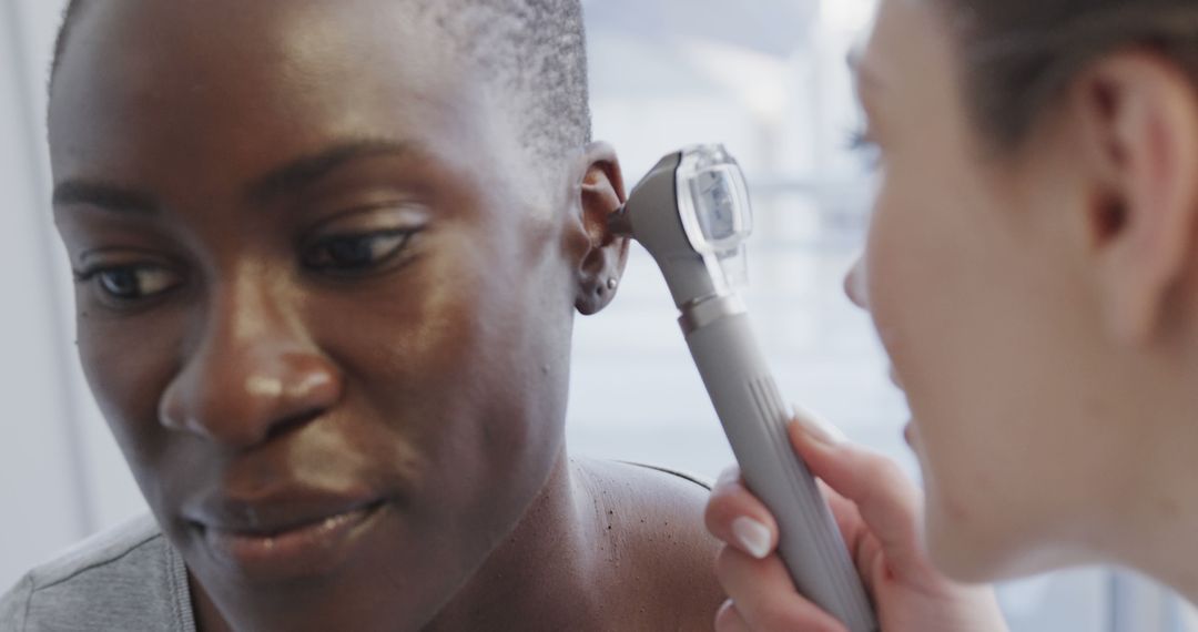 Female Doctor Examining Ear of Patient with Otoscope - Free Images, Stock Photos and Pictures on Pikwizard.com