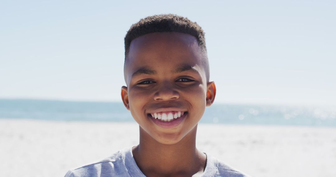 Smiling African American Boy Enjoying Sunny Beach Day - Free Images, Stock Photos and Pictures on Pikwizard.com