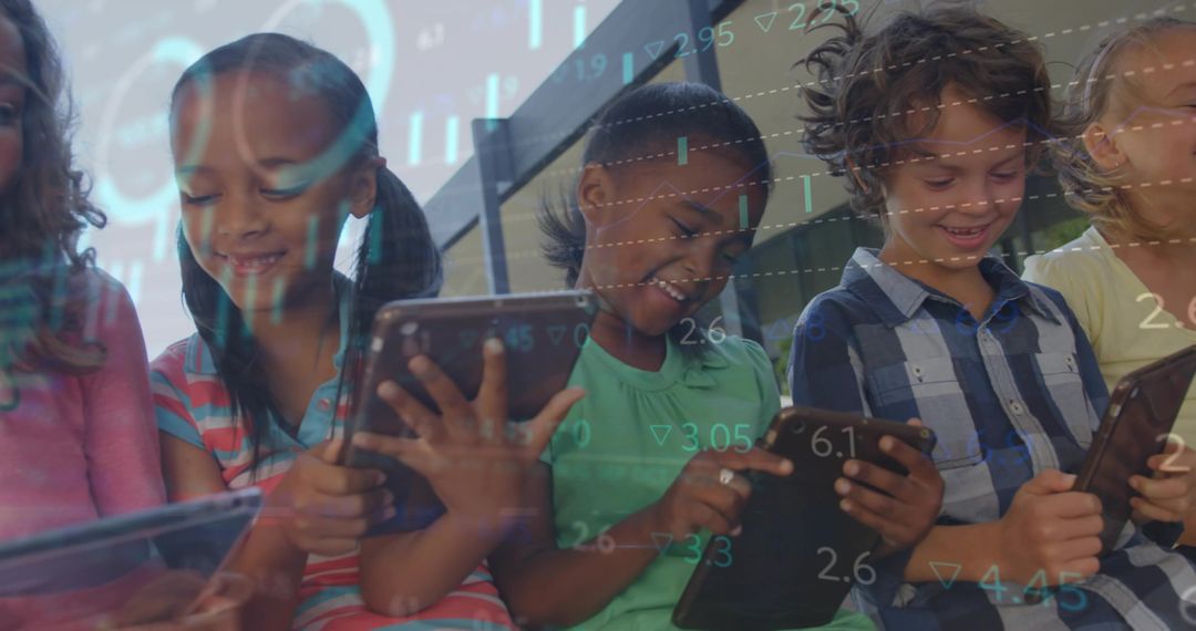 Smiling children using tablets with digital analytics overlay for STEM learning and collaboration