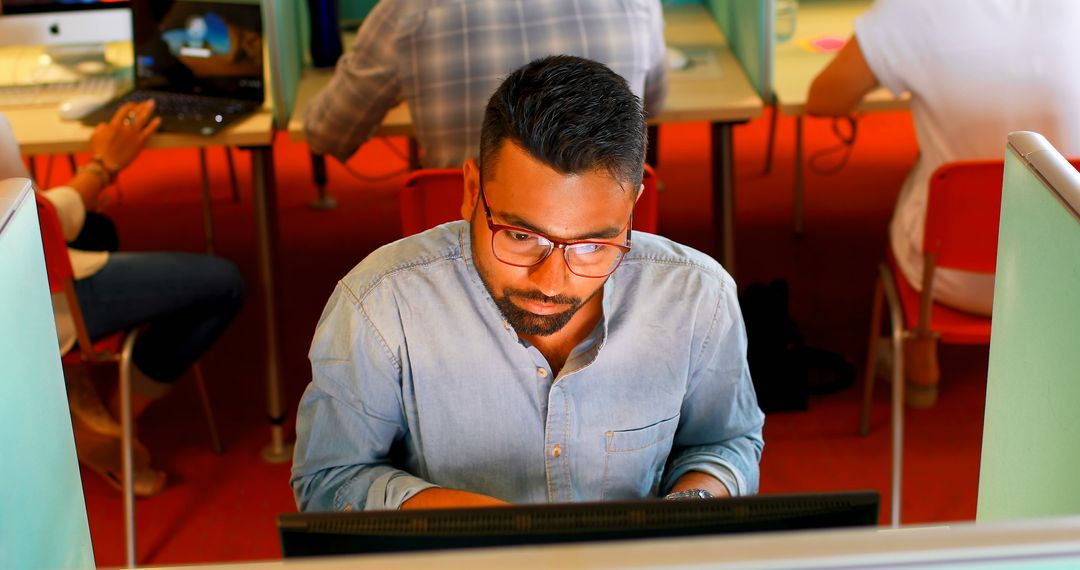 Professional Man in Glasses Working Intensively at Computer