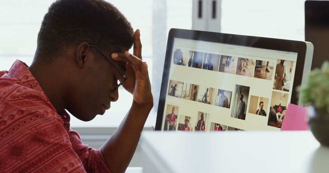 Stressed Designer Staring at Computer Screen in Modern Office