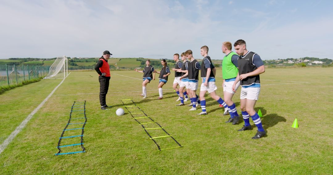 Coach Leading Youth Soccer Team in Ladder Drills on Grassy Field