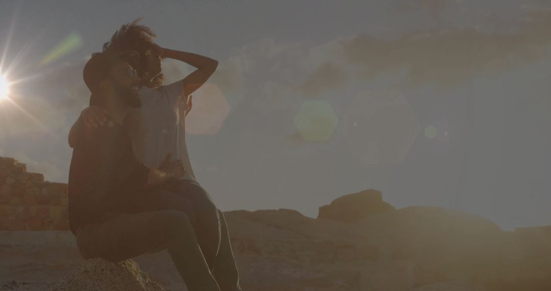 Romantic Couple Embracing at Sunset on Desert Rocks