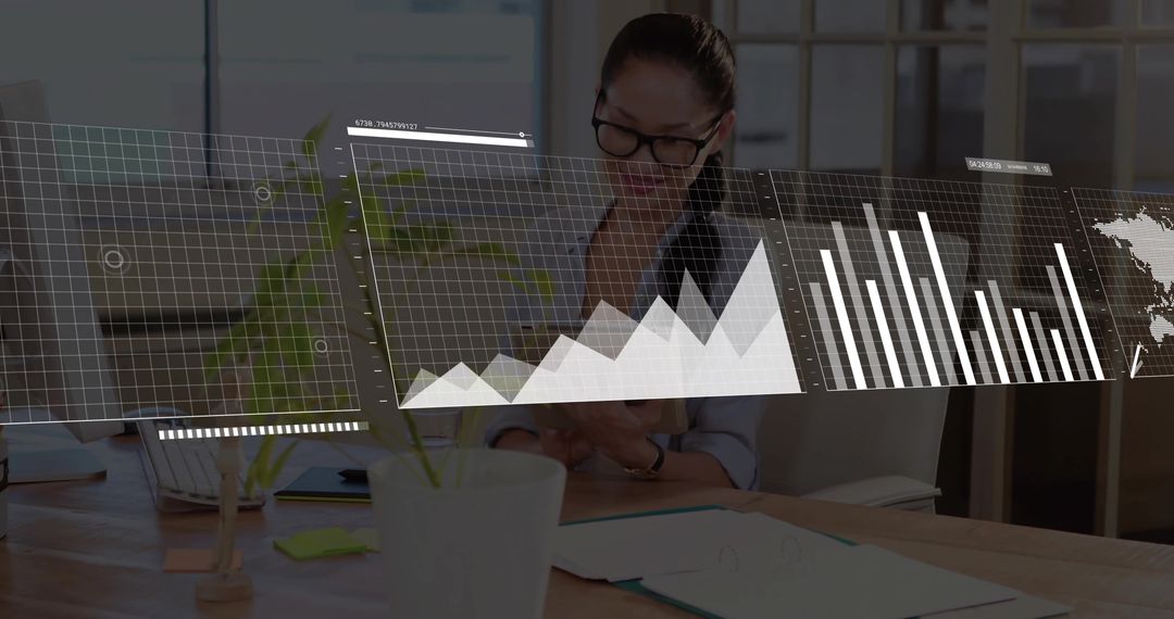 Asian businesswoman reviewing reports and mobile data analytics at modern office desk