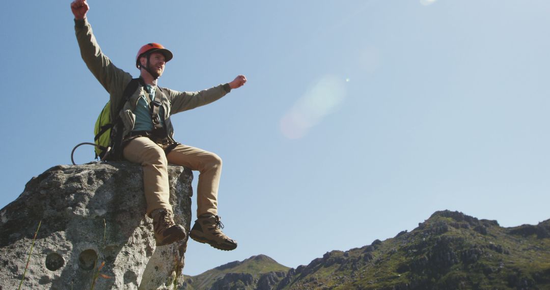 Hiker Celebrating on Mountain Peak Under Clear Blue Sky - Free Images, Stock Photos and Pictures on Pikwizard.com