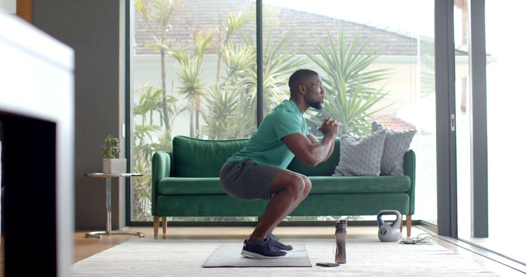 Man Performing Deep Squats in Stylish Living Room Home Workout