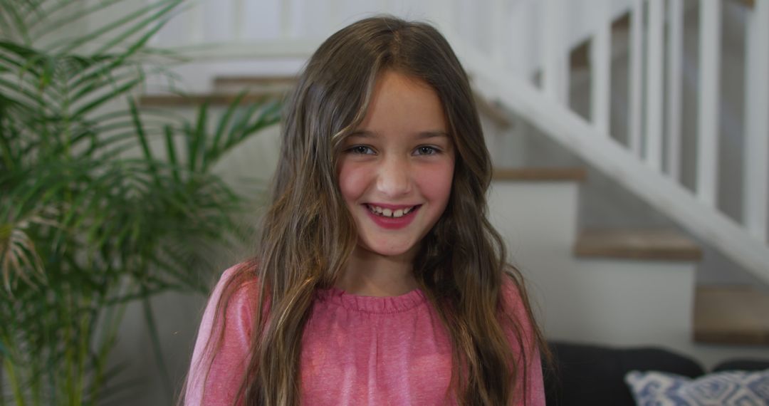 Smiling Young Girl with Long Hair Standing Indoors - Free Images, Stock Photos and Pictures on Pikwizard.com