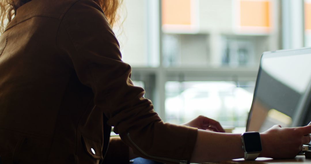 Female Executive Multitasking with Laptop and Smartphone in Office