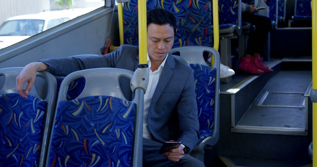 Businessman Using Smartphone While Traveling on Public Bus - Free Images, Stock Photos and Pictures on Pikwizard.com