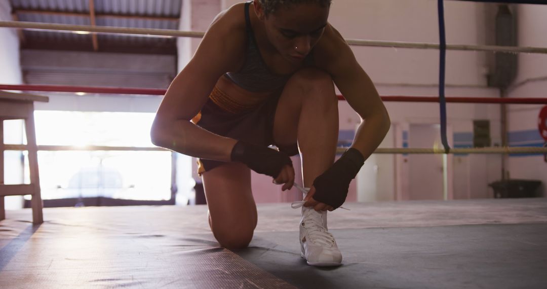 Female Boxer Lacing Up Shoes in Training Gym - Free Images, Stock Photos and Pictures on Pikwizard.com