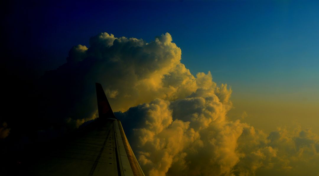 Dramatic Sky with Clouds from Airplane Window During Sunset - Free Images, Stock Photos and Pictures on Pikwizard.com