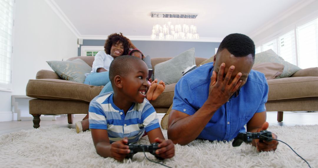 Father and Son Enjoying Video Games Together on Living Room Floor - Free Images, Stock Photos and Pictures on Pikwizard.com