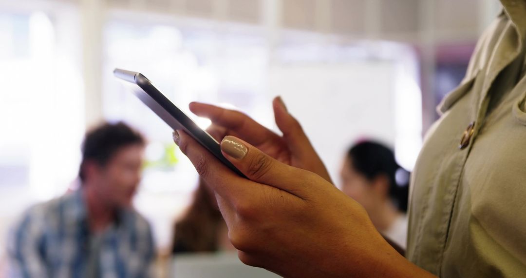 Close-up of Woman Tapping Smartphone in Coworking Office Hands Interacting with Mobile