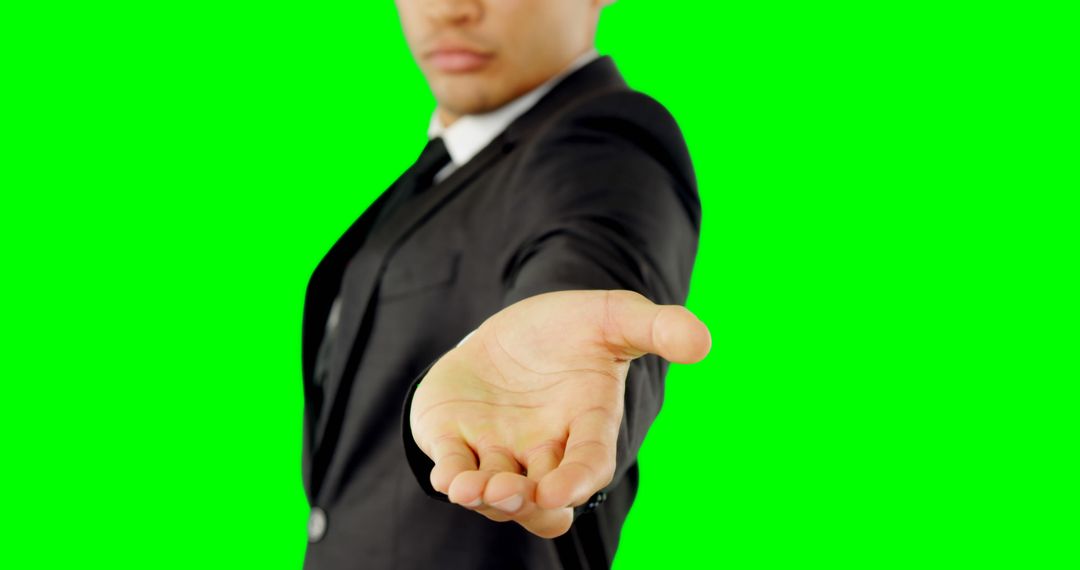 Businessman Reaching Out with Hand Extended on Green Screen - Free Images, Stock Photos and Pictures on Pikwizard.com