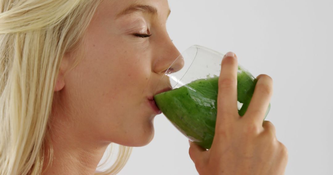 Young Woman Drinking Healthy Green Smoothie with Eyes Closed - Free Images, Stock Photos and Pictures on Pikwizard.com