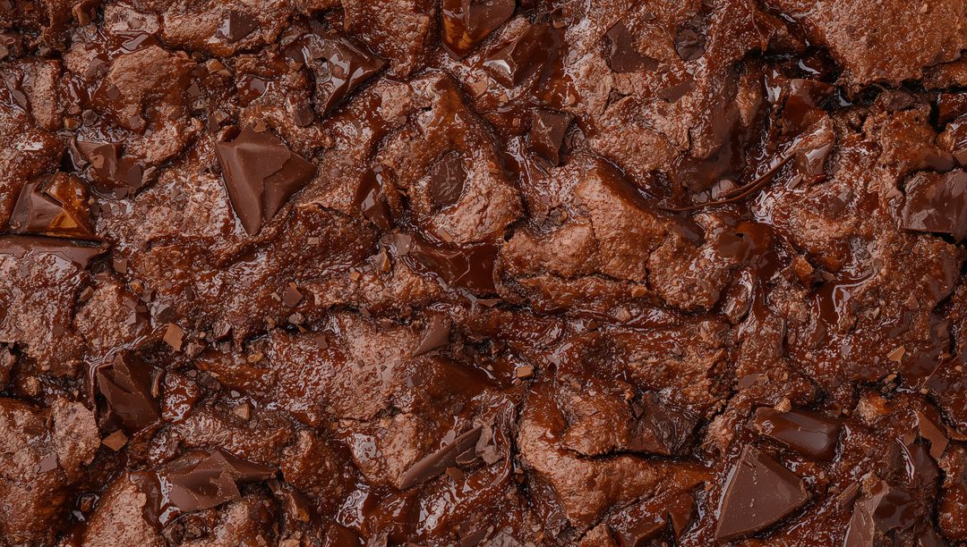 Glistening Fudgy Chocolate Brownie Surface with Melting Chocolate Chunks