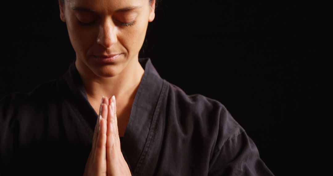 Woman Practicing Martial Arts Meditation in Black Gi - Free Images, Stock Photos and Pictures on Pikwizard.com