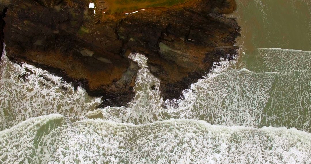 Powerful Ocean Waves Crashing Against Rocky Shoreline - Free Images, Stock Photos and Pictures on Pikwizard.com