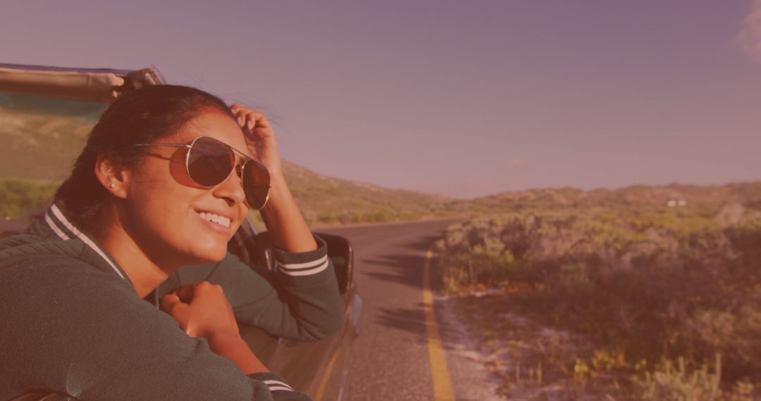 Image of happy biracial woman wearing glasses, driving a cabriolet - Free Images, Stock Photos and Pictures on Pikwizard.com