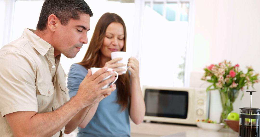 Couple Enjoying Morning Coffee in Kitchen - Free Images, Stock Photos and Pictures on Pikwizard.com