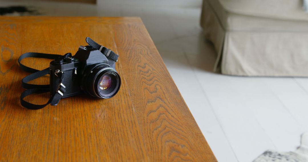 Classic Camera Lying On Wooden Table in Bright Living Room - Free Images, Stock Photos and Pictures on Pikwizard.com