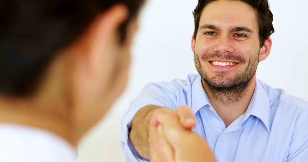 Smiling Businessman Shaking Hands in Meeting - Free Images, Stock Photos and Pictures on Pikwizard.com