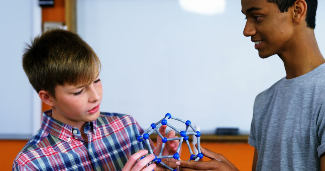 Diverse Students Collaborating on STEM Project with Geometric Model in Classroom - Free Images, Stock Photos and Pictures on Pikwizard.com