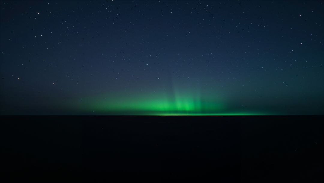 Glowing Aurora Borealis Ribbon Dancing Above Dark Ocean Horizon Under Starry Sky