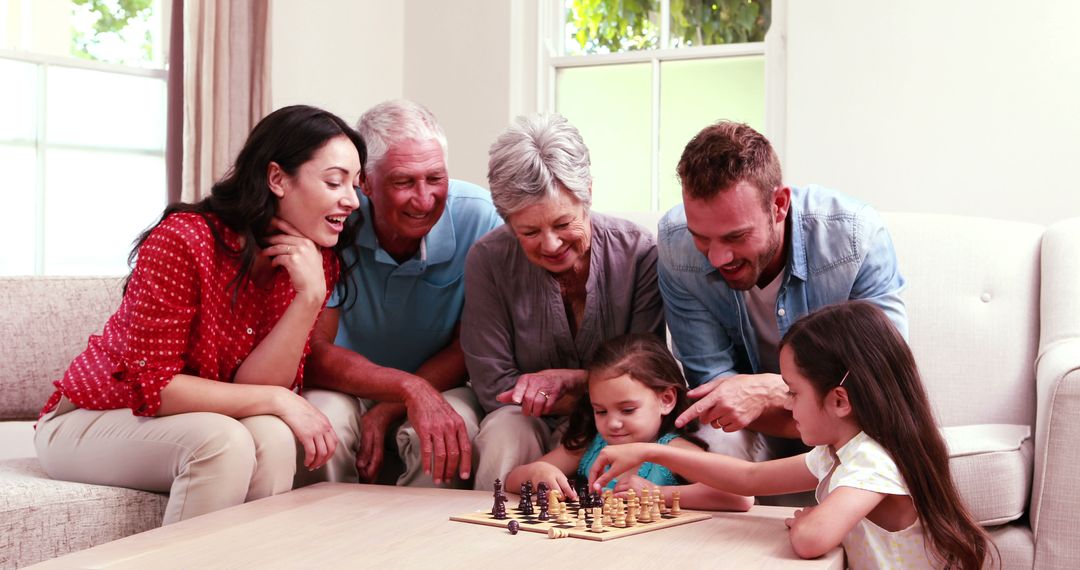 Multigenerational family playing chess, bonding in living room - Free Images, Stock Photos and Pictures on Pikwizard.com