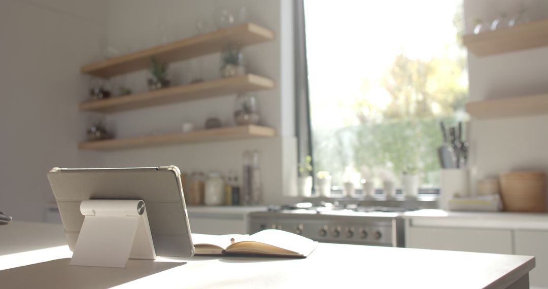 Modern Kitchen with Tablet on White Countertop in Sunlight