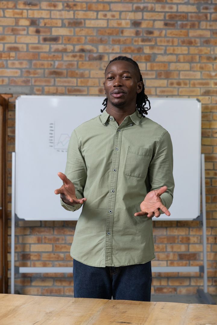 Confident Instructor Presenting Line Graph in Classroom Setting