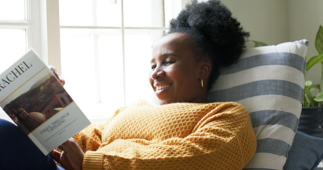 Woman Relaxing on Couch, Reading Book by Window - Free Images, Stock Photos and Pictures on Pikwizard.com