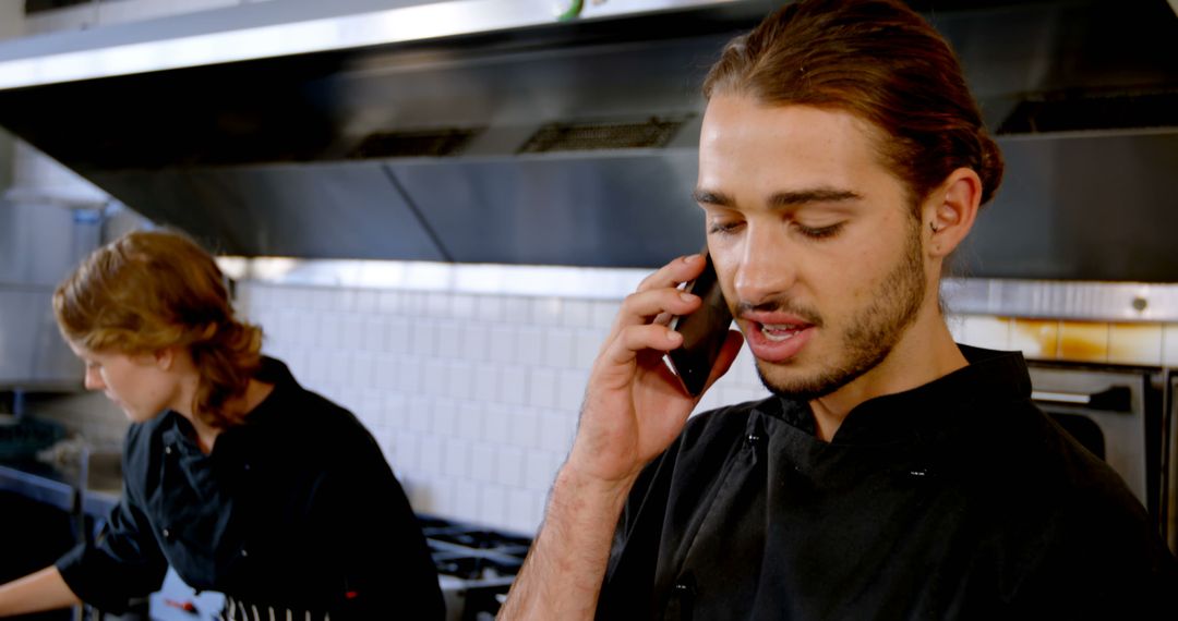 Young Chef Talking on Phone in Professional Kitchen - Free Images, Stock Photos and Pictures on Pikwizard.com