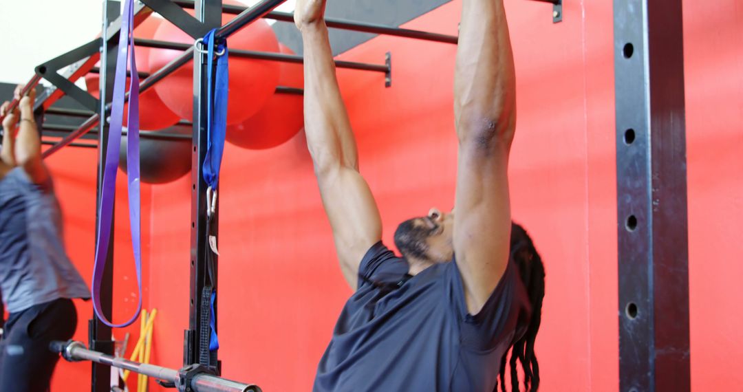 Young Man Doing Pull-Ups at Gym - Free Images, Stock Photos and Pictures on Pikwizard.com