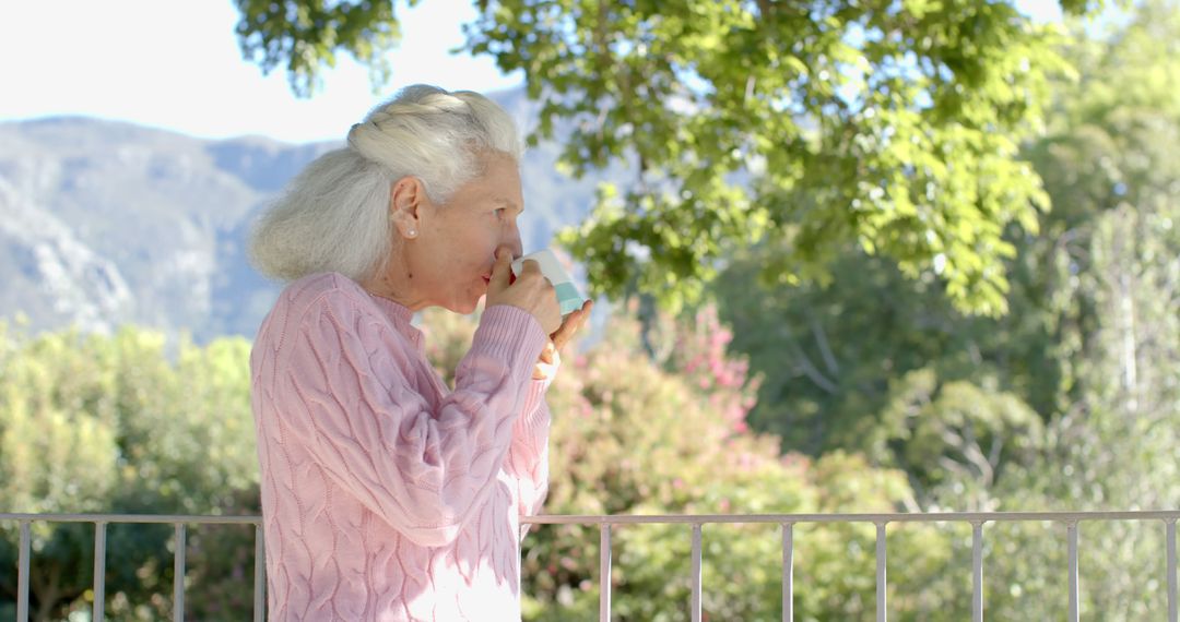 Elderly Woman Enjoying Beverage on Balcony - Free Images, Stock Photos and Pictures on Pikwizard.com