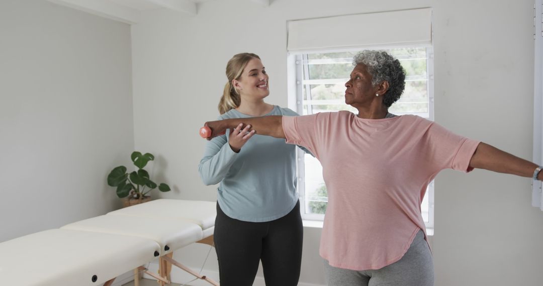 Senior Woman Doing Arm Exercises with Physical Therapist - Free Images, Stock Photos and Pictures on Pikwizard.com