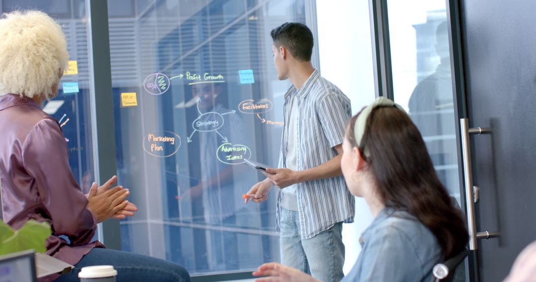 Team Brainstorming Business Strategies in Modern Office