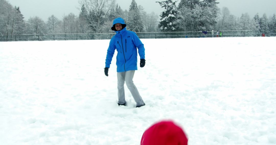 Person Playing in Snowy Field with Winter Clothes - Free Images, Stock Photos and Pictures on Pikwizard.com