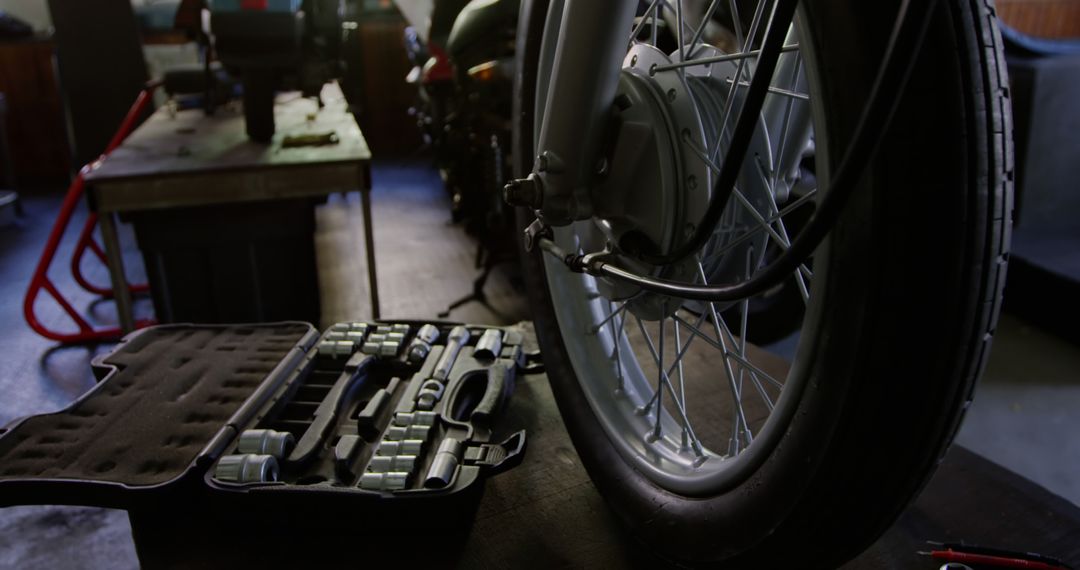 Motorcycle Wheel Maintenance with Tool Kit in Garage - Free Images, Stock Photos and Pictures on Pikwizard.com