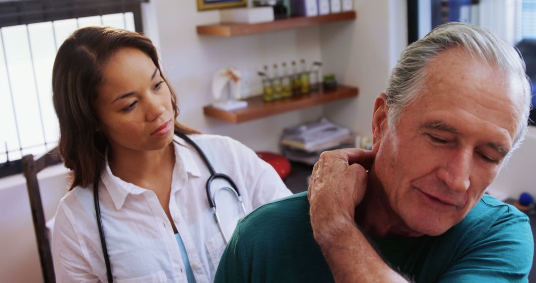 Doctor Checking Elderly Patient's Neck Pain in Medical Office - Free Images, Stock Photos and Pictures on Pikwizard.com