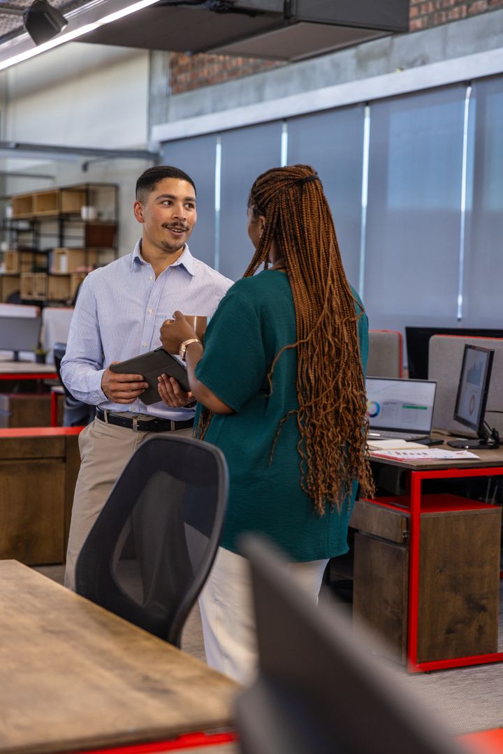 Colleagues Discussing Project in Modern Office with Tablet
