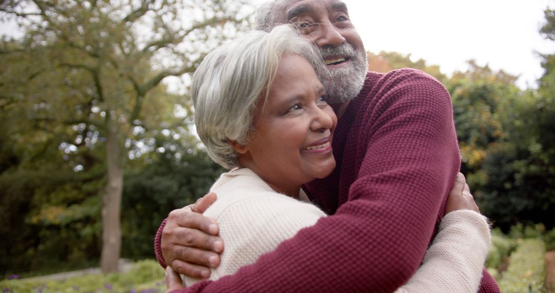 Senior Couple Embracing Outdoors with Joyful Smiles - Free Images, Stock Photos and Pictures on Pikwizard.com