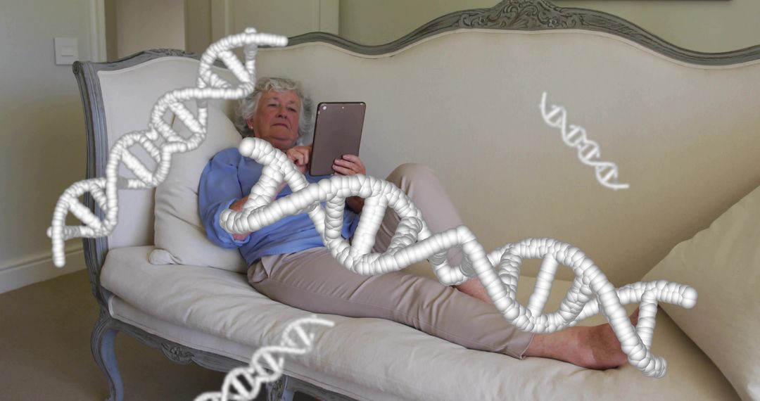 Senior woman relaxing on antique sofa using tablet with floating DNA helix overlays