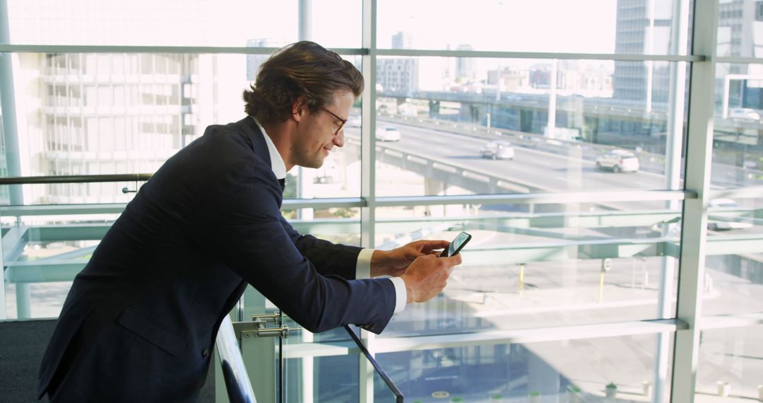 Businessman Texting on Smartphone in Modern Office - Free Images, Stock Photos and Pictures on Pikwizard.com